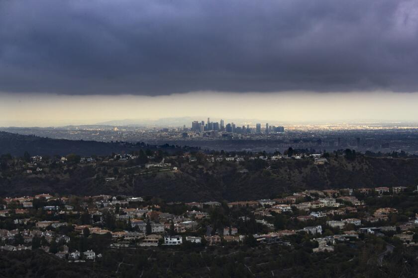 LOS ANGELES, CA - November 30: Clouds gather over the Los Angeles basin in a view to downtown Los Angeles from the Santa Monica Mountains over the mansions of Bel Air on Wednesday, Nov. 30, 2022 in Los Angeles, CA. (Brian van der Brug / Los Angeles Times)