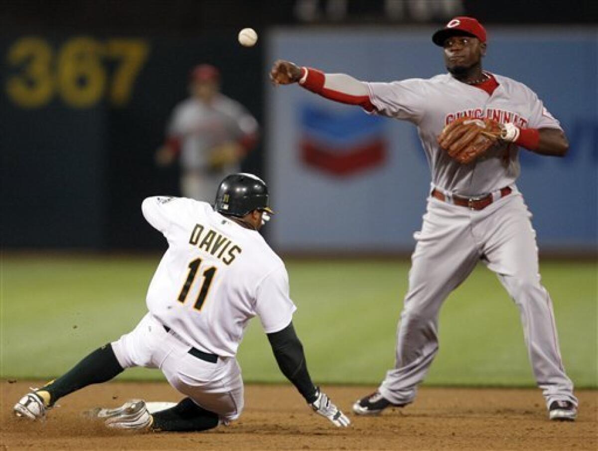 Brandon Phillips (4) throws to first base during the game between