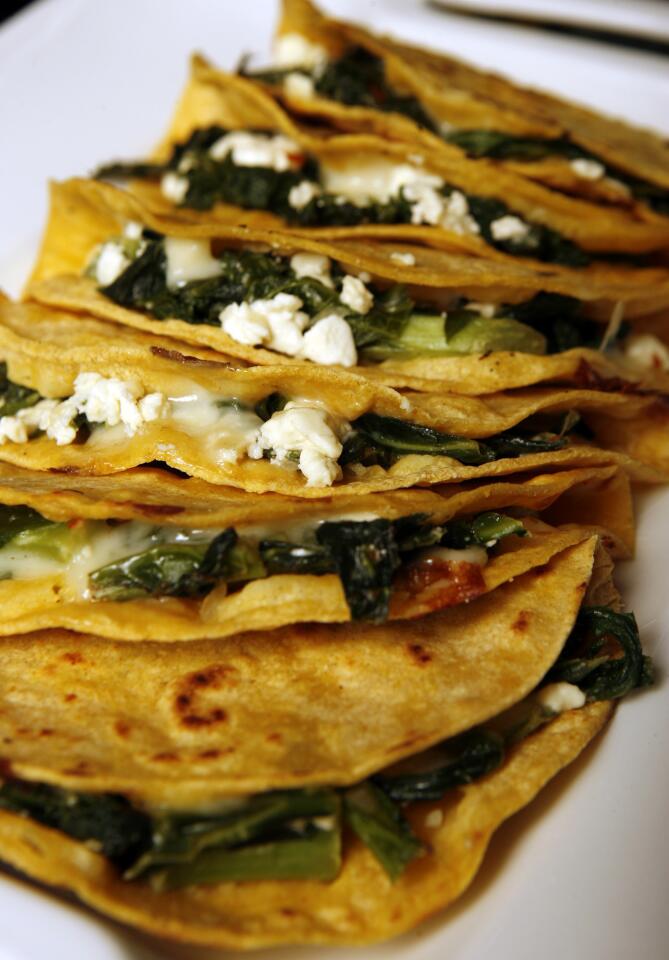 In this variation, tortillas are stuffed with quickly cooked greens and chunks of feta and mozzarella, the tortillas warmed until lightly browned and the cheese oozes just slightly. The recipe comes together in minutes, perfect after a long day.