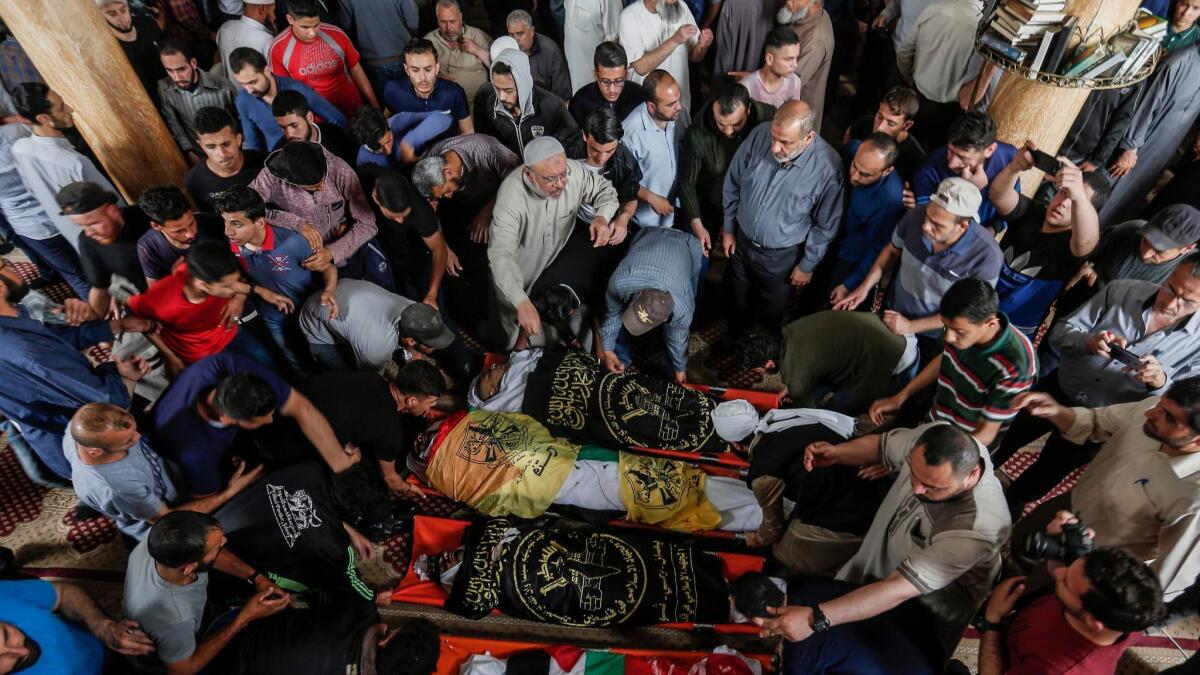 Mourners gather around the bodies of Palestinians who were killed in Israeli strikes the previous day, during a funeral ceremony at a mosque in Beit Lahiya, in the northern Gaza Strip.