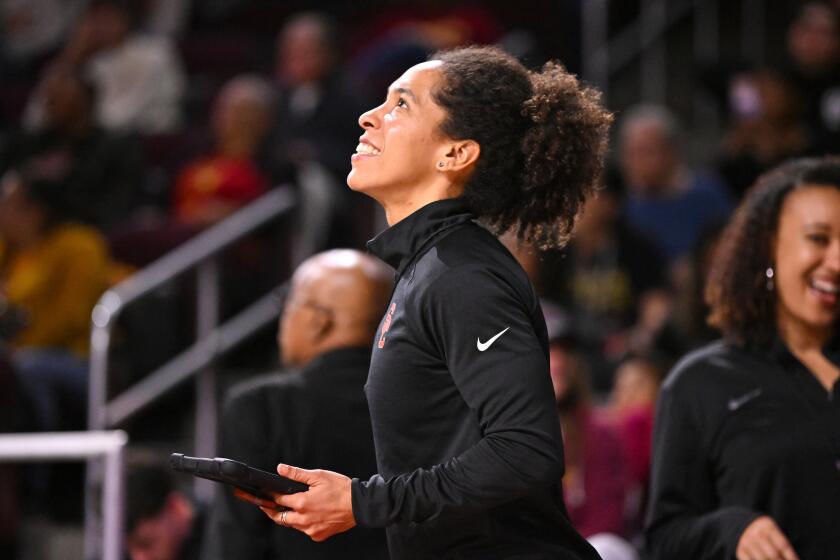 USC women's basketball strength and conditioning coach Kelly Dormandy looks up from the sideline during a game.