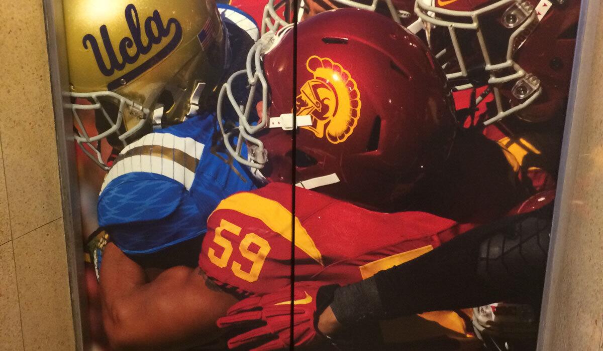 A giant photograph featuring suspended USC player Don Hill (59) adorns the press-box elevator door at the Coliseum.