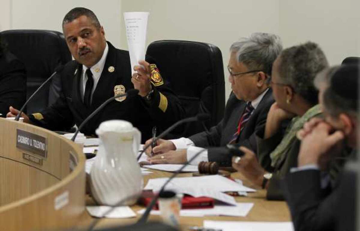L.A. Fire Chief Brian Cummings left, talks to members of the city Fire Commission about 911 response times at a meeting in March.