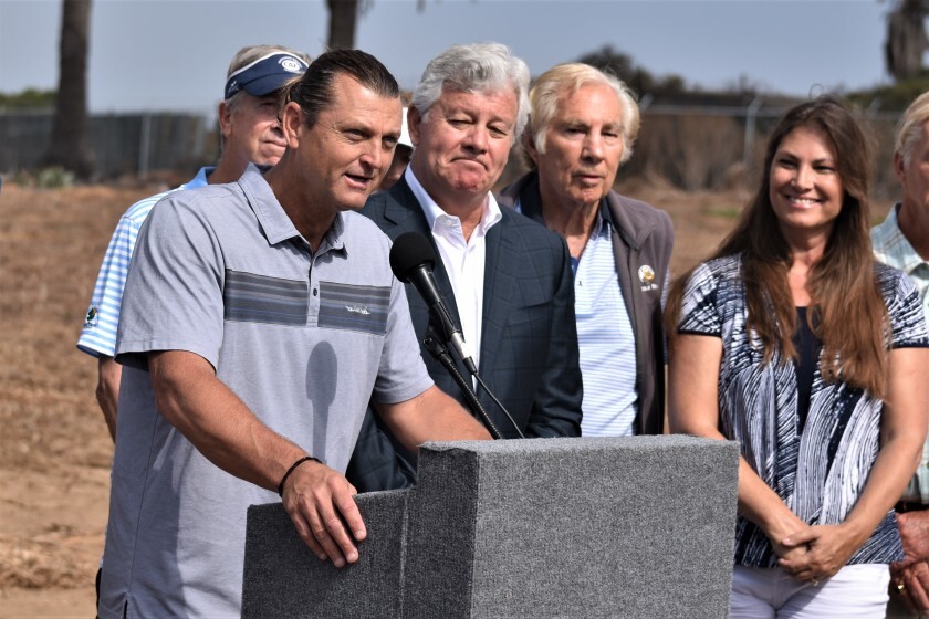 Backed by project principals, retired Padres closer Trevor Hoffman, left, signals his support the Marisol bluff-top development in Del Mar Monday, Aug. 5.