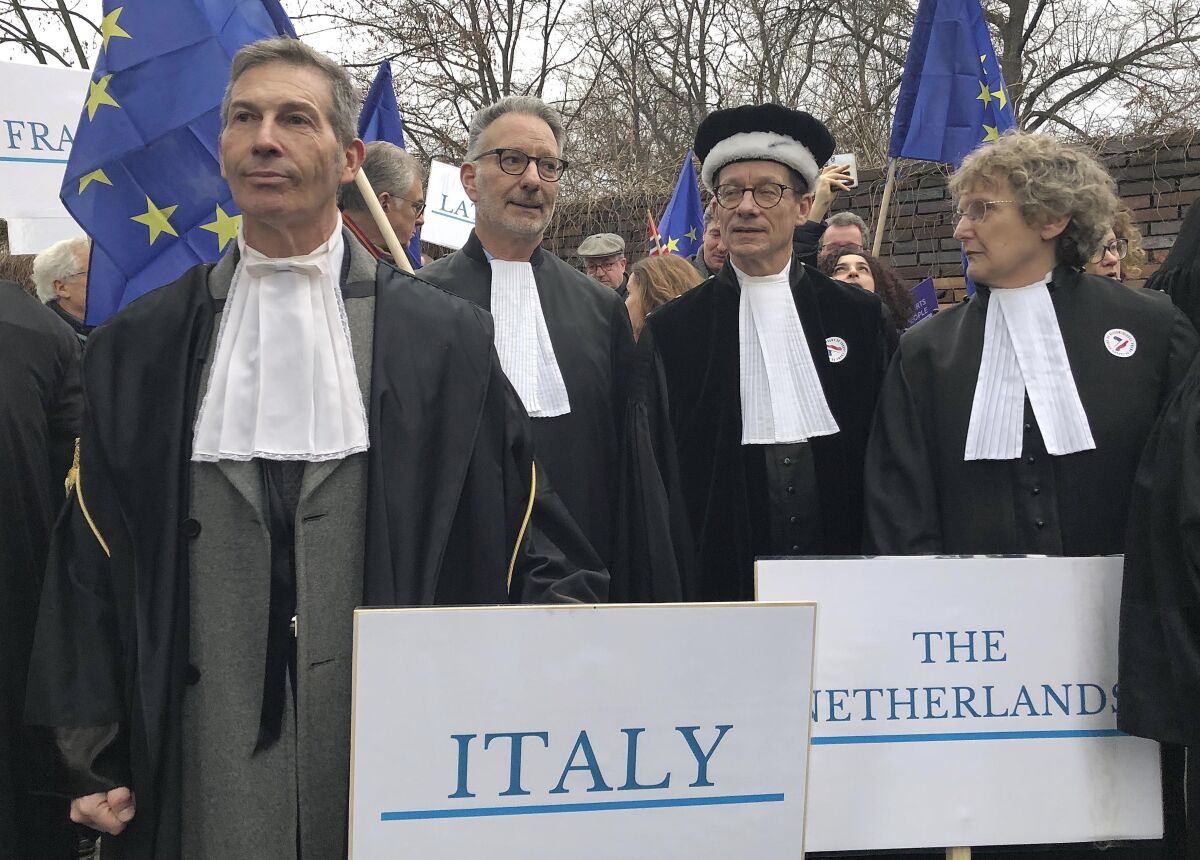 FILE - Judges from Italy, the Netherlands and elsewhere in Europe, many wearing their professional gowns, take part in a march in support of judicial independence in Warsaw, Poland, Jan. 11, 2020. A centrist group in the European Union legislature has on Wednesday, June 1, 2022 demanded an “urgent” explanation amid reports the EU’s executive arm is preparing to release billions of euros to Poland’s government. If true, Poland would have access to 36 billion euros (about $39 billion) in pandemic recovery funds even though the nation’s populist government has failed to reverse changes to the judicial system that an EU court deemed illegal. (AP Photo/Vanessa Gera)