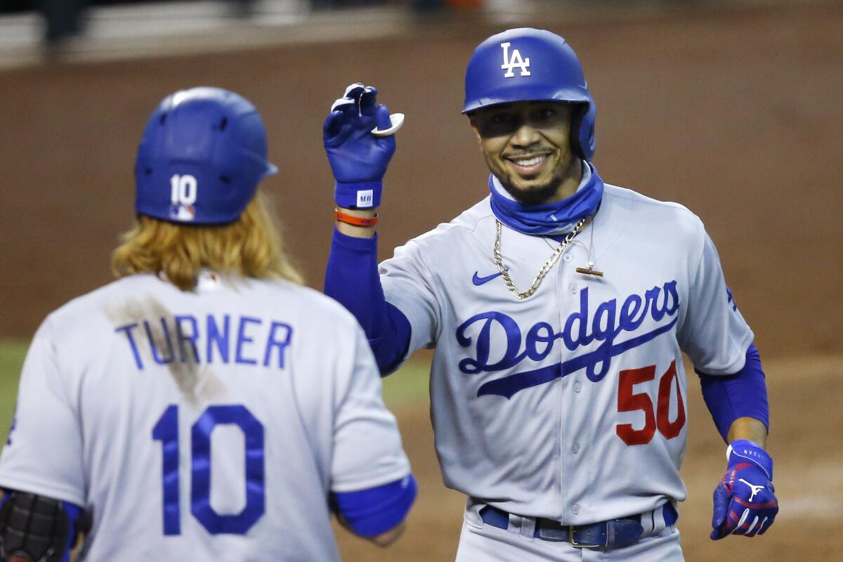 Mookie Betts, right, is in the Dodgers lineup for the first game of a doubleheader Thursday.