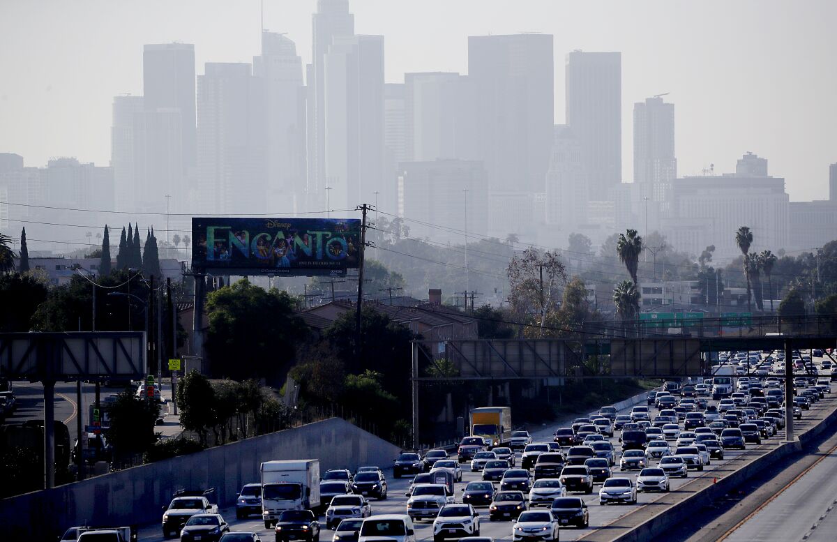 Heavy traffic on the 10 Freeway with downtown Los Angeles in the background.