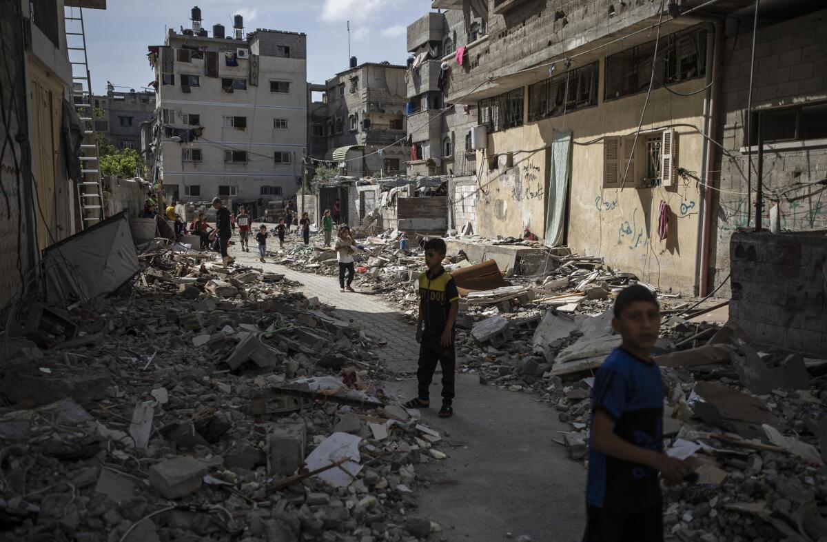 Children look over a bombed house in Gaza City.