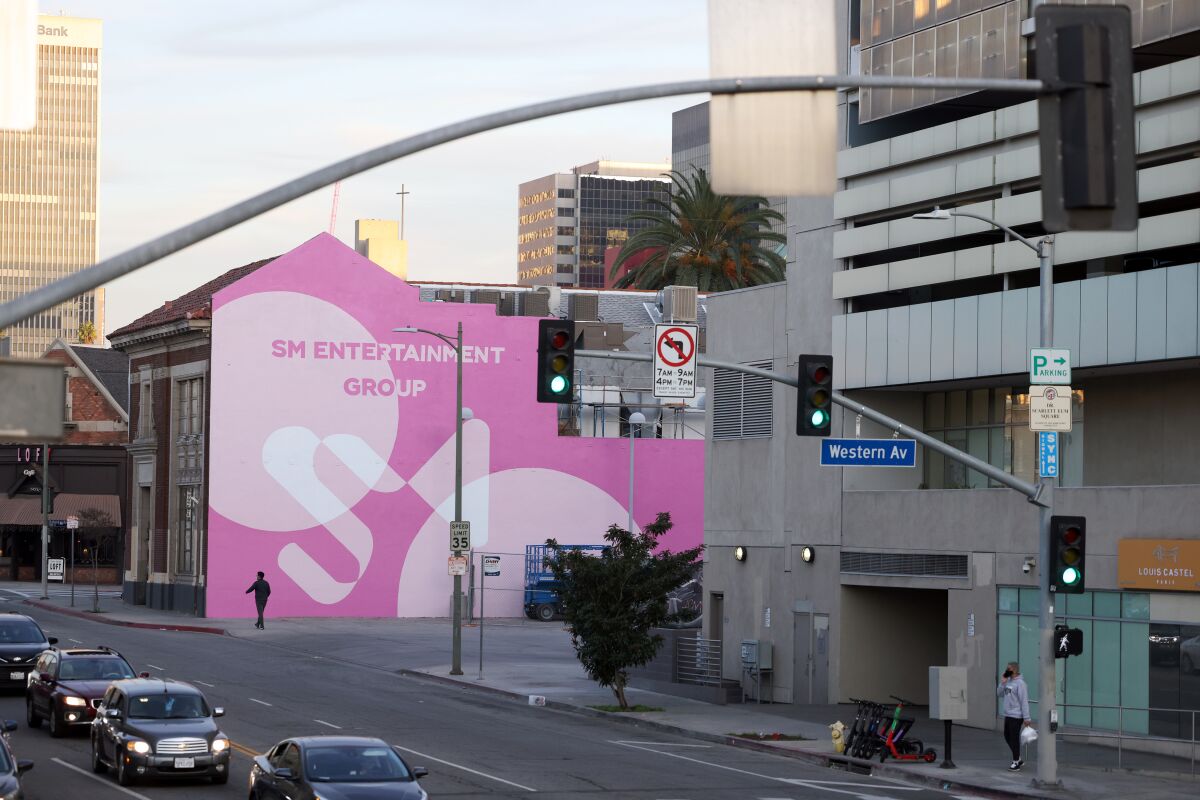 A building with a pink mural that says "SM Entertainment Group"