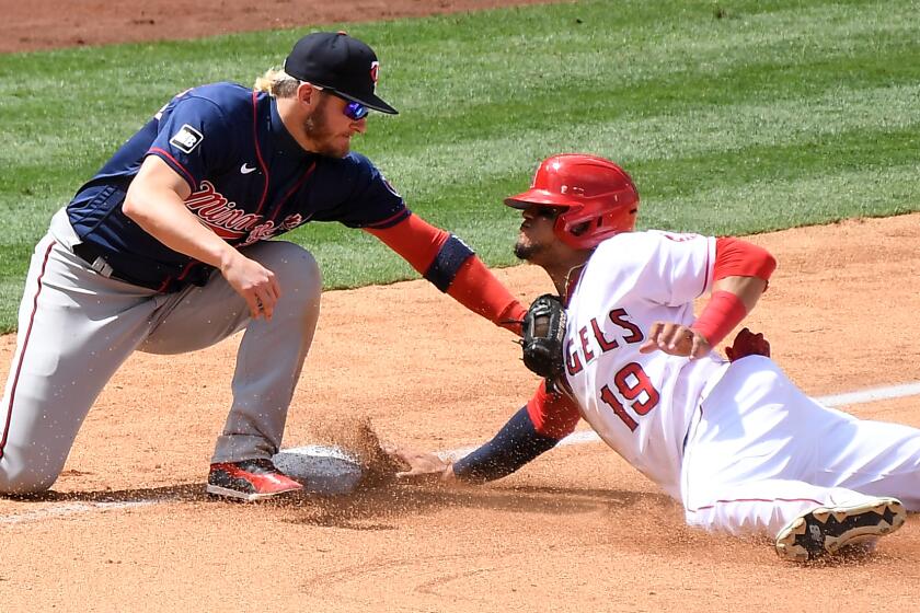 ANAHEIM-CA-MAY 20, 2021: Angels Juan Lagares is tagged out by Twins 3rd baseman Josh Donaldson while trying to steal third base in the 5th inning. (Wally Skalij / Los Angeles Times)