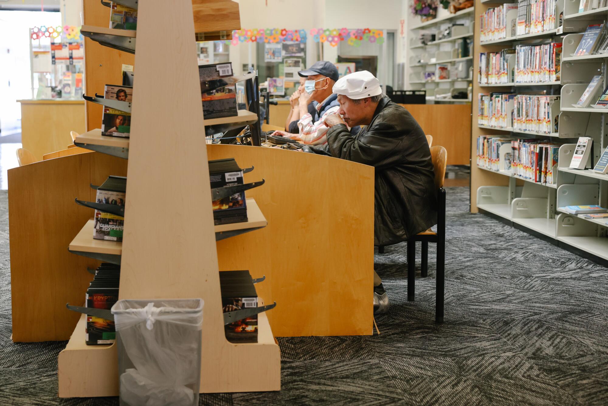 People utilize the shared computer spaces at the Chinatown Branch