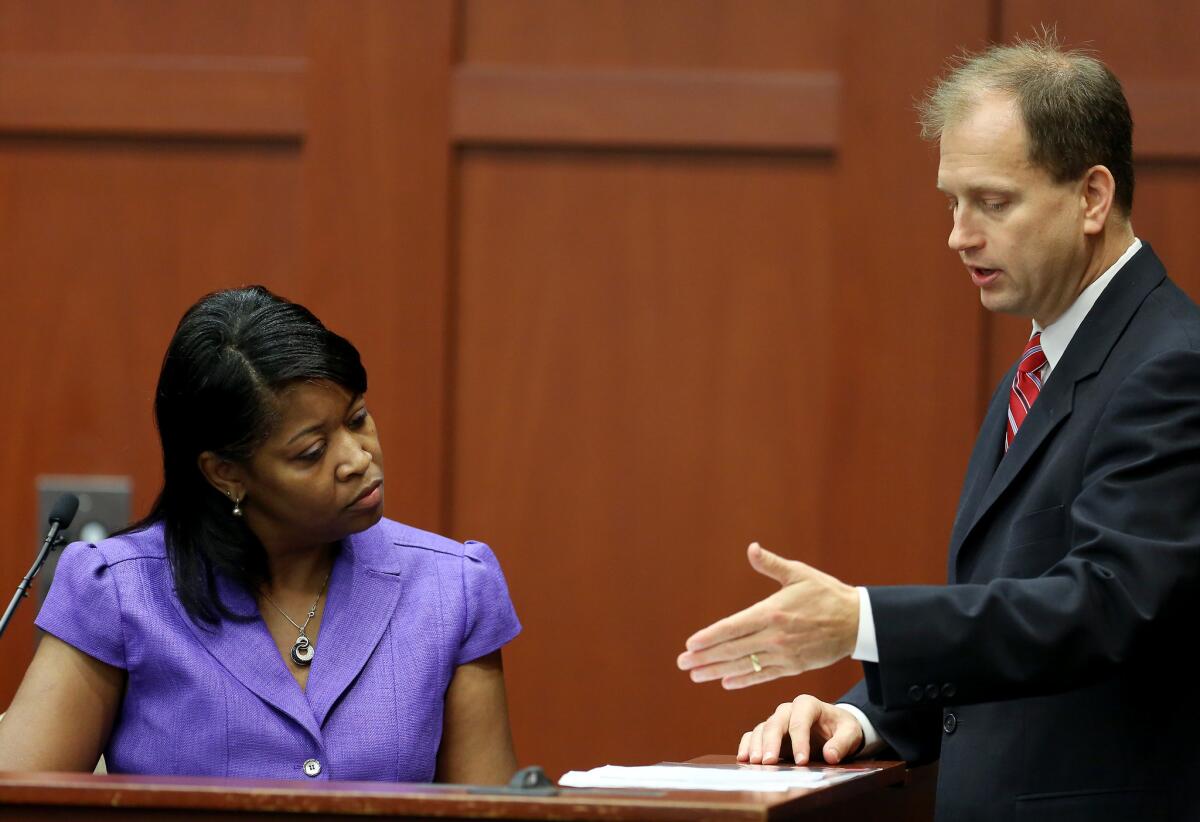Sonja Boles-Melvin, registrar for Seminole State College, looks at a document presented by Assistant State Attorney Richard Mantei, during the George Zimmerman trial in Seminole County circuit court, in Sanford, Fla.