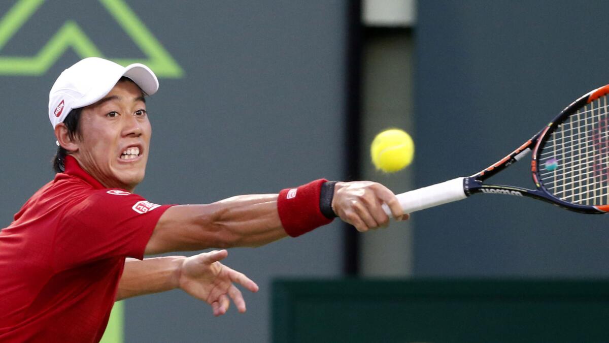 Kei Nishikori returns a shot against Nick Kyrgios during a semifinal match at the Miami Open on Friday.