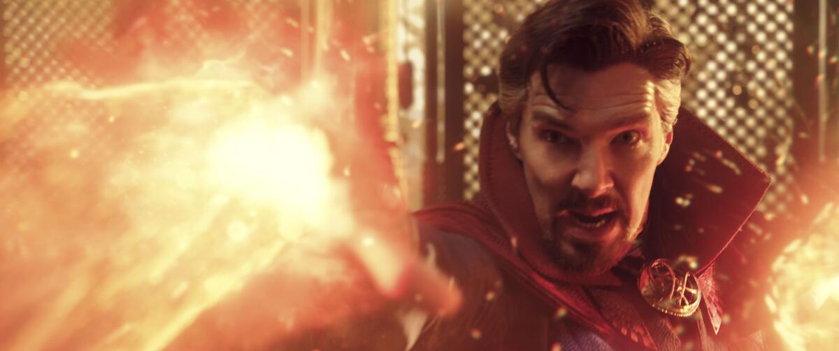Benedict Cumberbatch hurls a fireball as Doctor Strange.