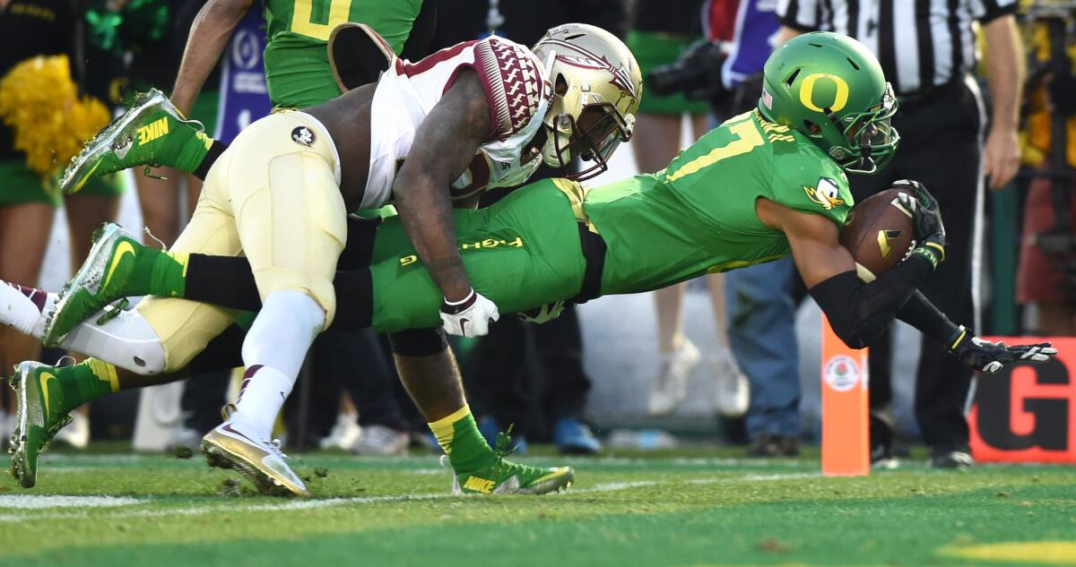 Oregon receiver Darren Carrington dives into the end zone before Florida State defensive back Trey Marshall can prevent the touchdown in the third quarter.