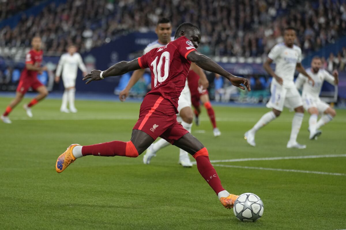 FILE - Liverpool's Sadio Mane passes the ball during the Champions League final soccer match between Liverpool and Real Madrid at the Stade de France in Saint Denis near Paris, Saturday, May 28, 2022. Sadio Mané looks to be headed for Bayern Munich in a move that will end his trophy-filled six-year stint at Liverpool. A person familiar with the situation says Liverpool has reached an agreement with the German champions for the transfer of the Senegal forward in a total package worth $42.9 million. (AP Photo/Kirsty Wigglesworth, File)
