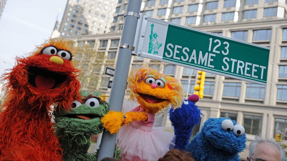 "Sesame Street" characters pose next to a street sign at West 64th Street and Broadway in New York in 2009, on the eve of the 40th anniversary of the broadcast of the children's television show.