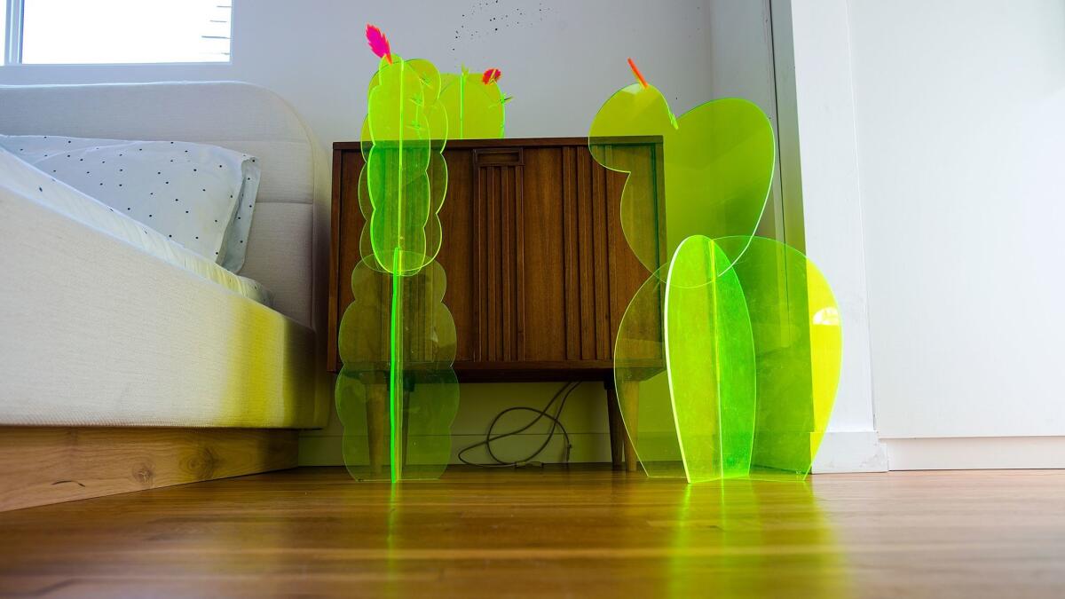 Neon floor fixtures rest next to the bed in the newly remodeled home and studio. (Gina Ferazzi / Los Angeles Times)