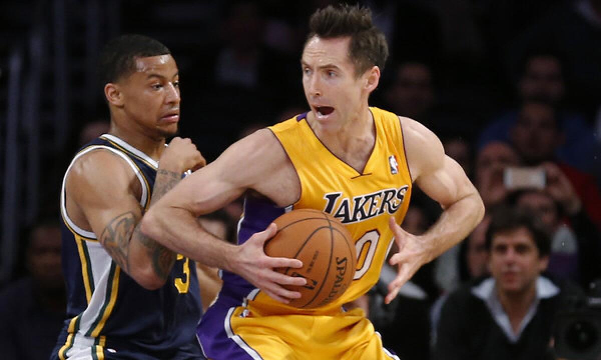 Lakers guard Steve Nash, right, tries to move past Utah Jazz guard Trey Burke during a Feb. 11 game. Nash is only five assists away from ranking third all-time in NBA career assists.
