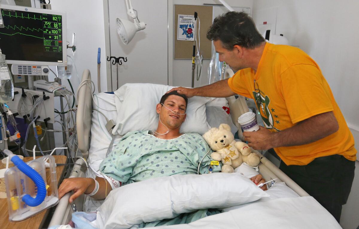 Dale Carney visits his son Joey in the intensive care unit the morning after Joey had surgery to donate 40% of his liver to his mother. Paula, at UCSF Medical Center in San Francisco.