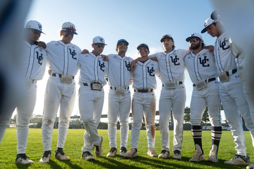 UC San Diego players lock arms at Triton Ballpark during weekend sweep of Long Beach State.