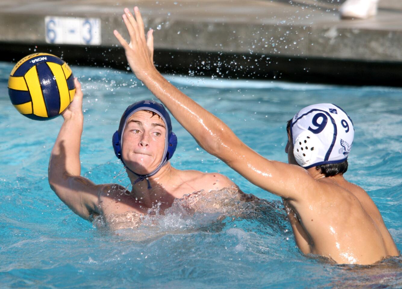 Flintridge Prep water polo player #11 Sean King takes a shot and scores even under pressure from Brentwood School's #9 Jared Rubin in home game in La Cañada Flintridge on Friday, October 23, 2015. FP won the game 13-7 after a 9-1 lead at the half.