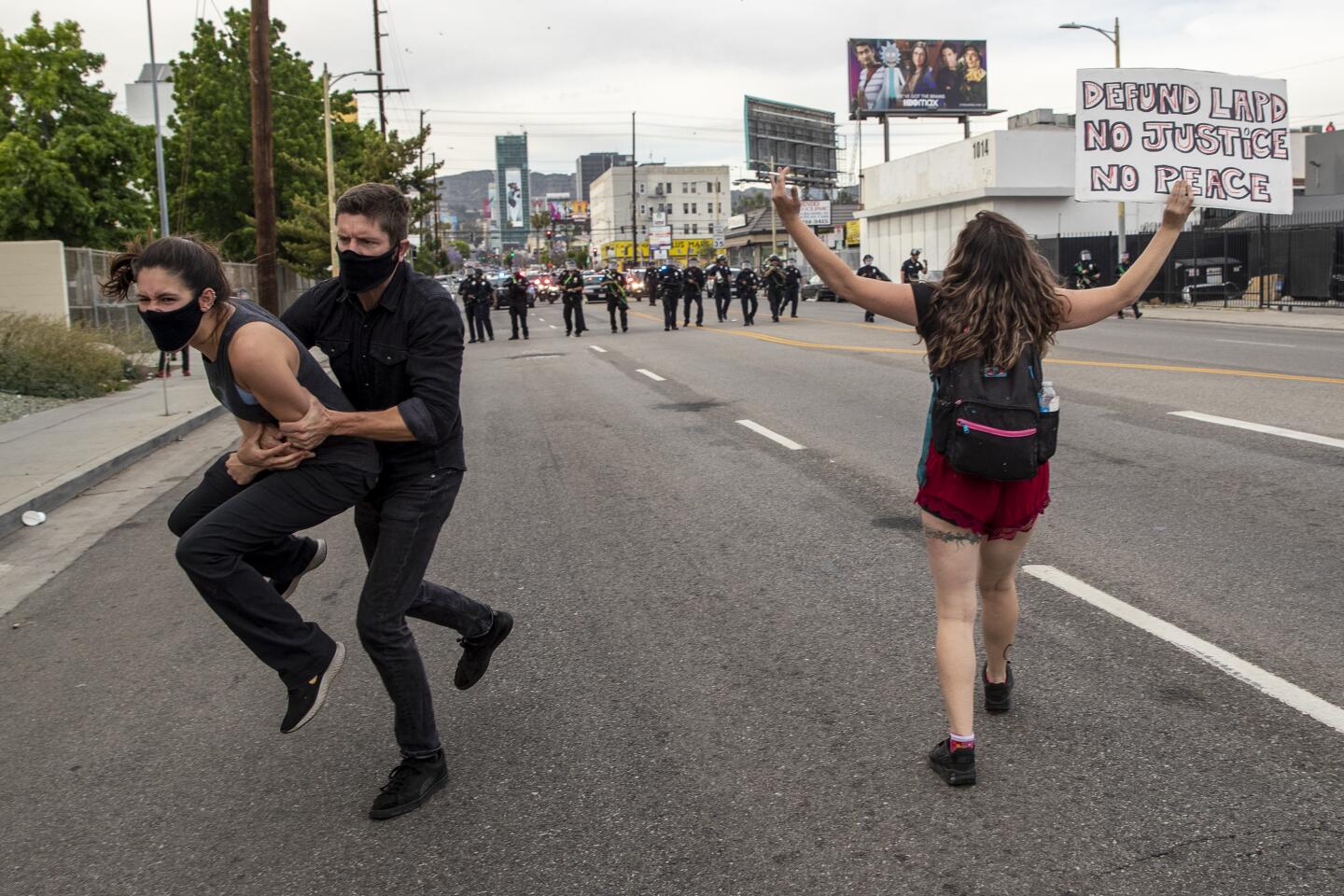 Police advance on a line of protesters in Hollywood, firing rubber bullets.