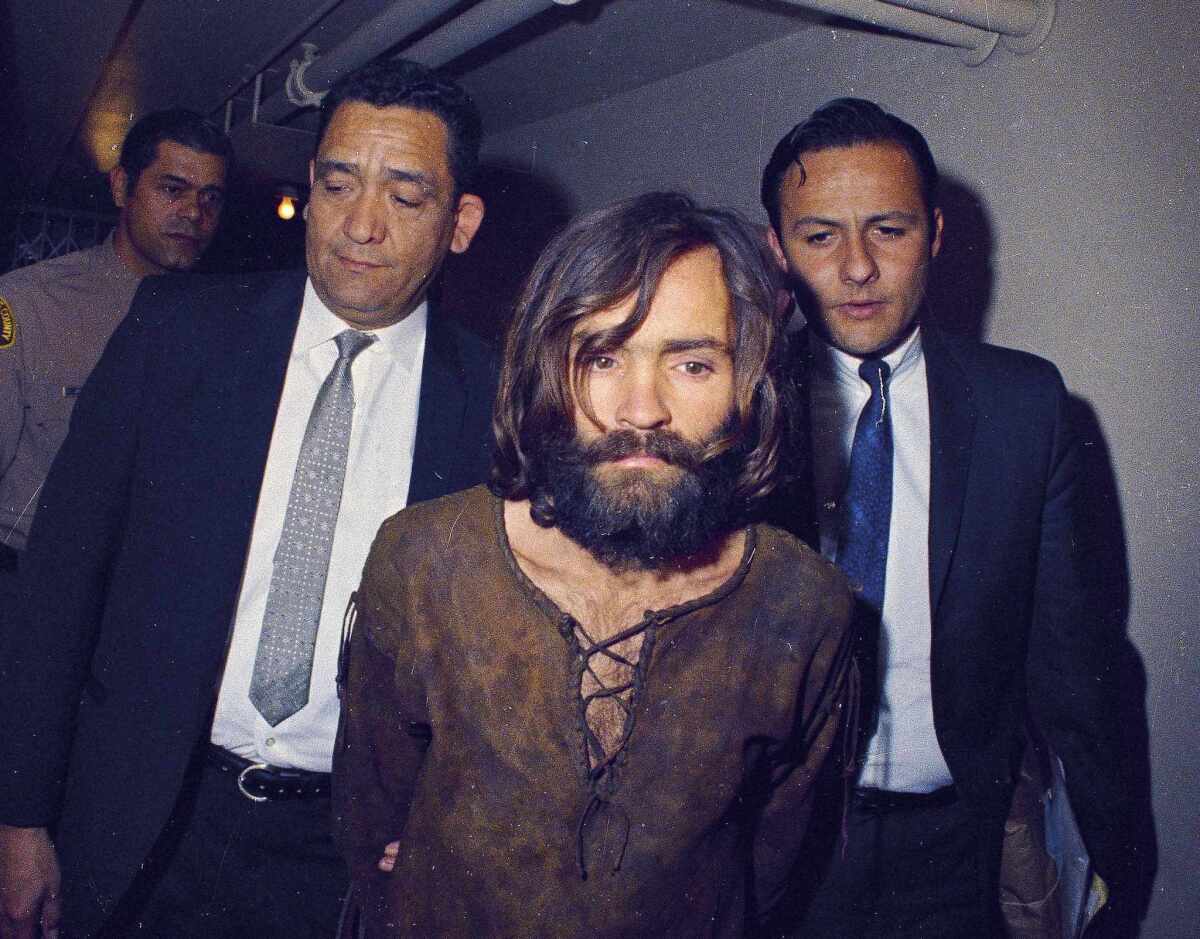 Charles Manson is escorted to his arraignment on conspiracy-murder charges in 1969.