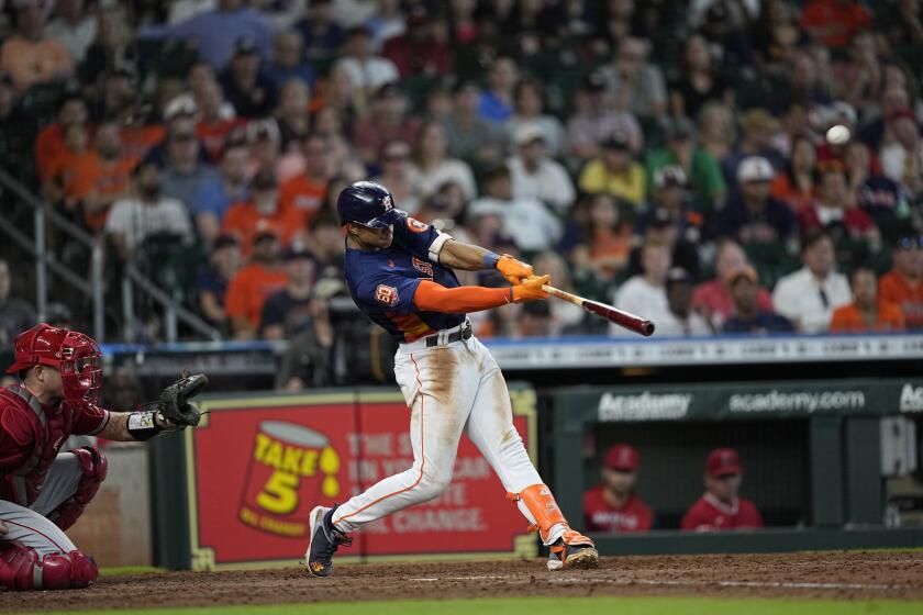 Houston Astros' Jeremy Pena, right, hits a walk-off two-run home run as Los Angeles Angels catcher Max Stassi reaches for the pitch during the ninth inning of a baseball game Sunday, July 3, 2022, in Houston. The Astros won 4-2. (AP Photo/David J. Phillip)