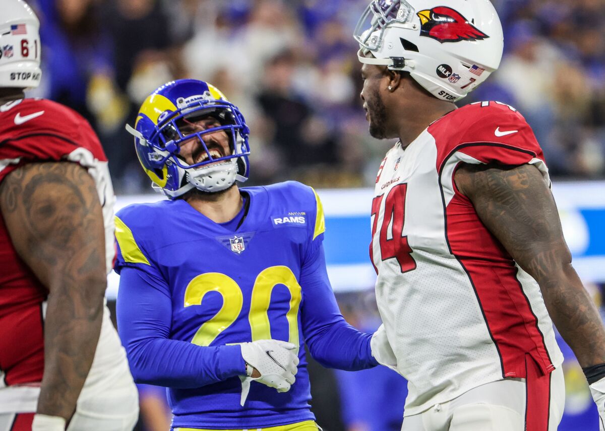 Rams safety Eric Weddle shares a laugh with Arizona Cardinals offensive tackle D.J. Humphries