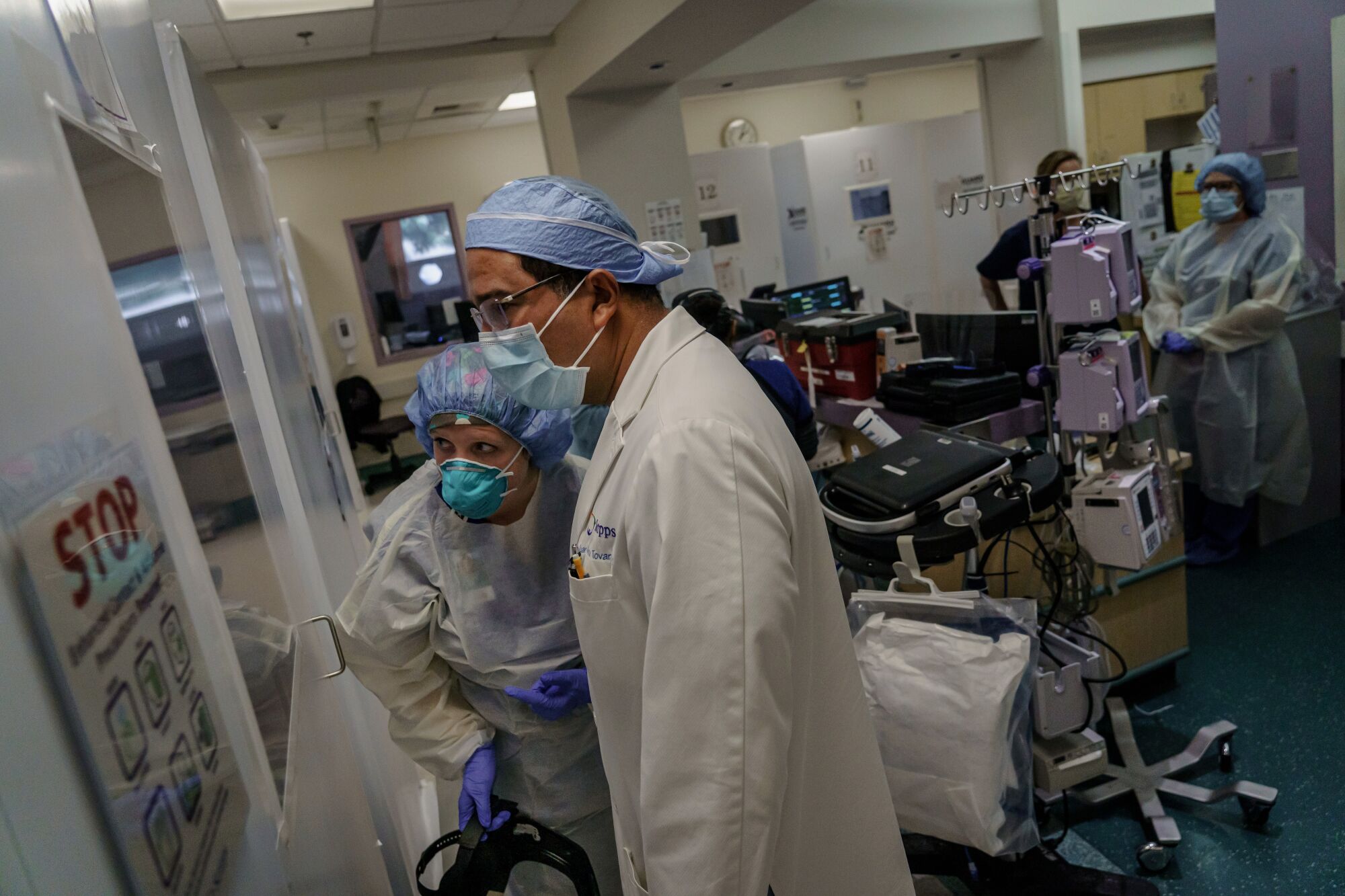 Doctor Juan Tovar, along with Nurse Practitioner Charlotte Thomas watch as an intubation is performed on a patient with COVID-19 symptoms, at the ICU at Scripps Mercy Hospital in Chula Vista, Calif., on April 23, 2020.