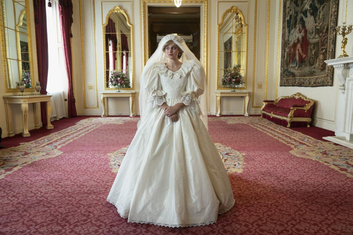 Diana, portrayed by Emma Corrin, wears the immense, puffy bridal gown created for her. 