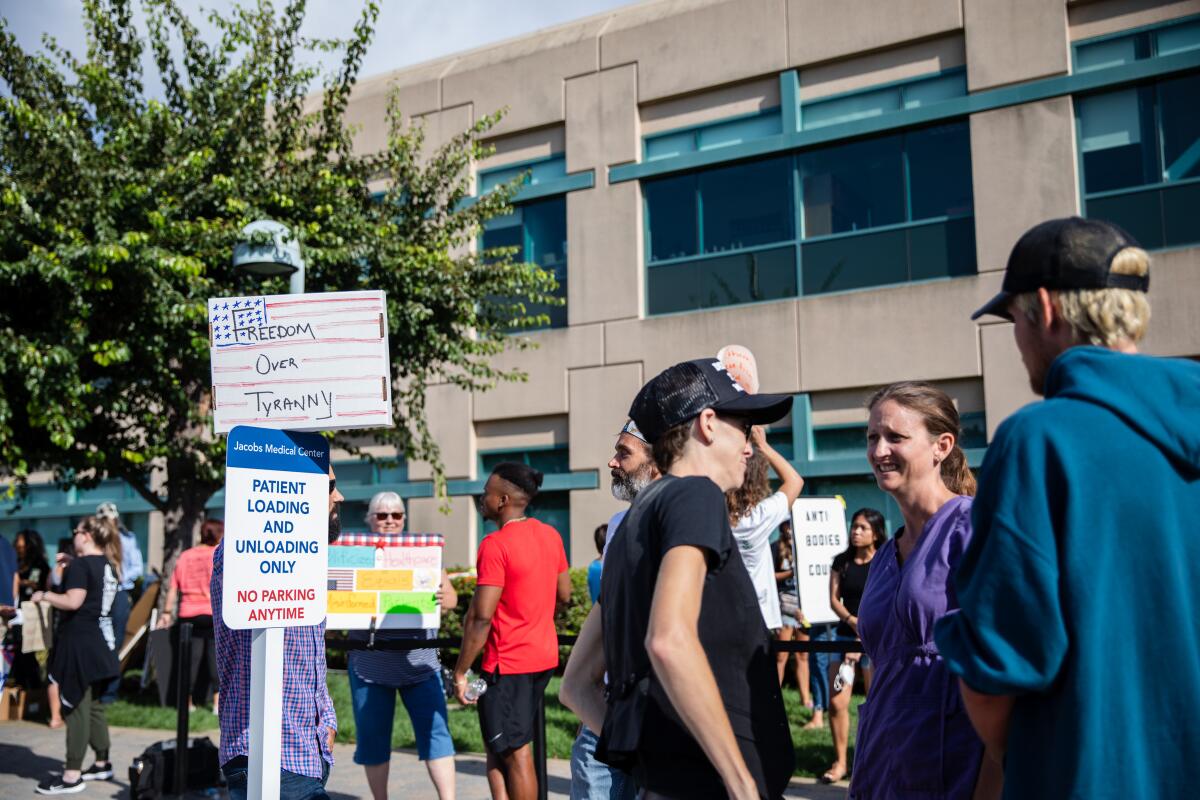 Demonstrators protest against vaccines outside Jacobs Medical Center at UC San Diego Health on Wednesday.