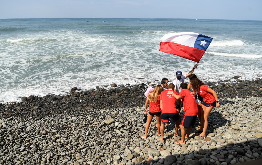 Team Chile cheers after competing in the ISA World Surfing Games at Surf City in El Salvador. 