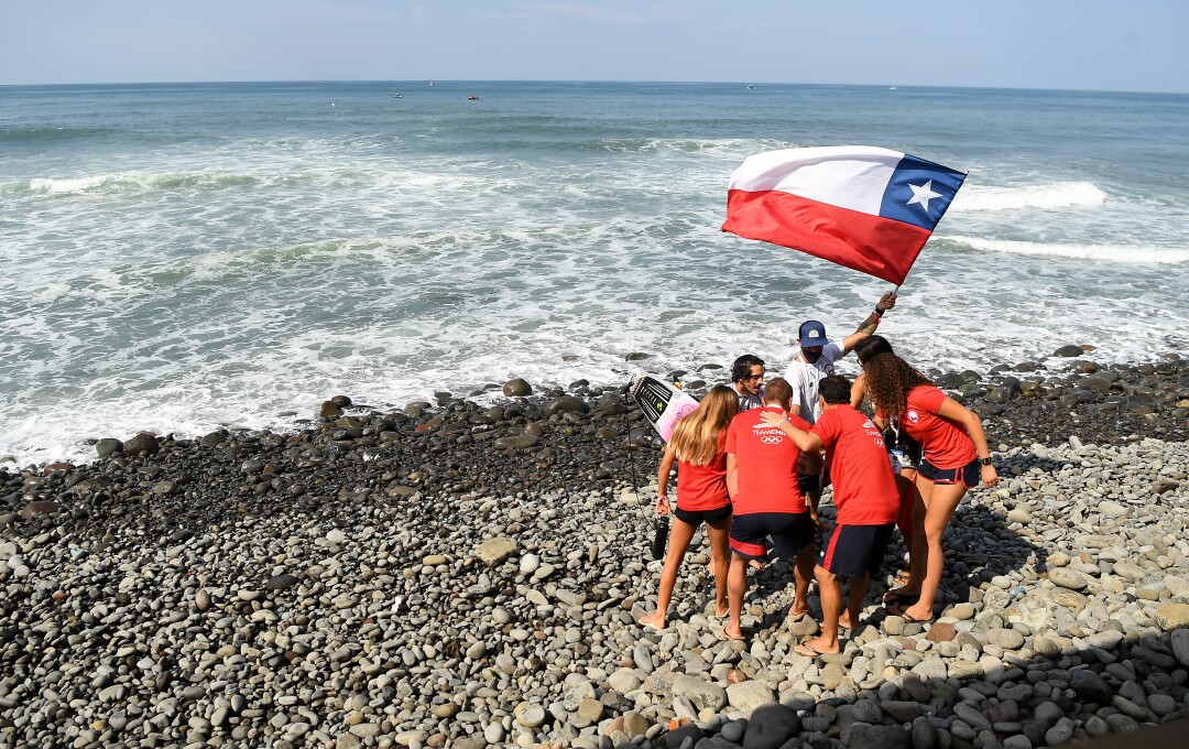 Team Chile cheers after competing in the ISA World Surfing Games at Surf City in El Salvador.