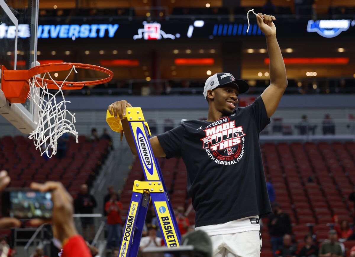 San Diego State's Lamont Butler cuts down the net after the Aztecs beat Creighton 57-56.