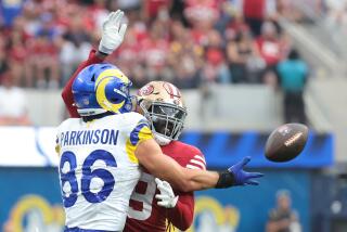 The Rams' Colby Parkinson can't make the catch before the 49ers' Deondre Campbell is called for a pass interference penalty.