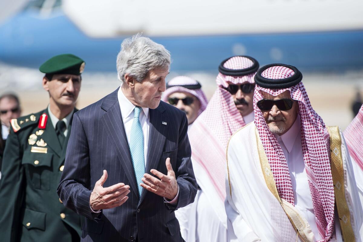 Saudi Foreign Minister Prince Saud al Faisal walks with U.S. Secretary of State John Kerry upon his arrival on June 27 at the airport in Jiddah. Kerry went to Saudi Arabia to meet the Syrian opposition, a day after hosting urgent talks on Syria and Iraq in Paris.