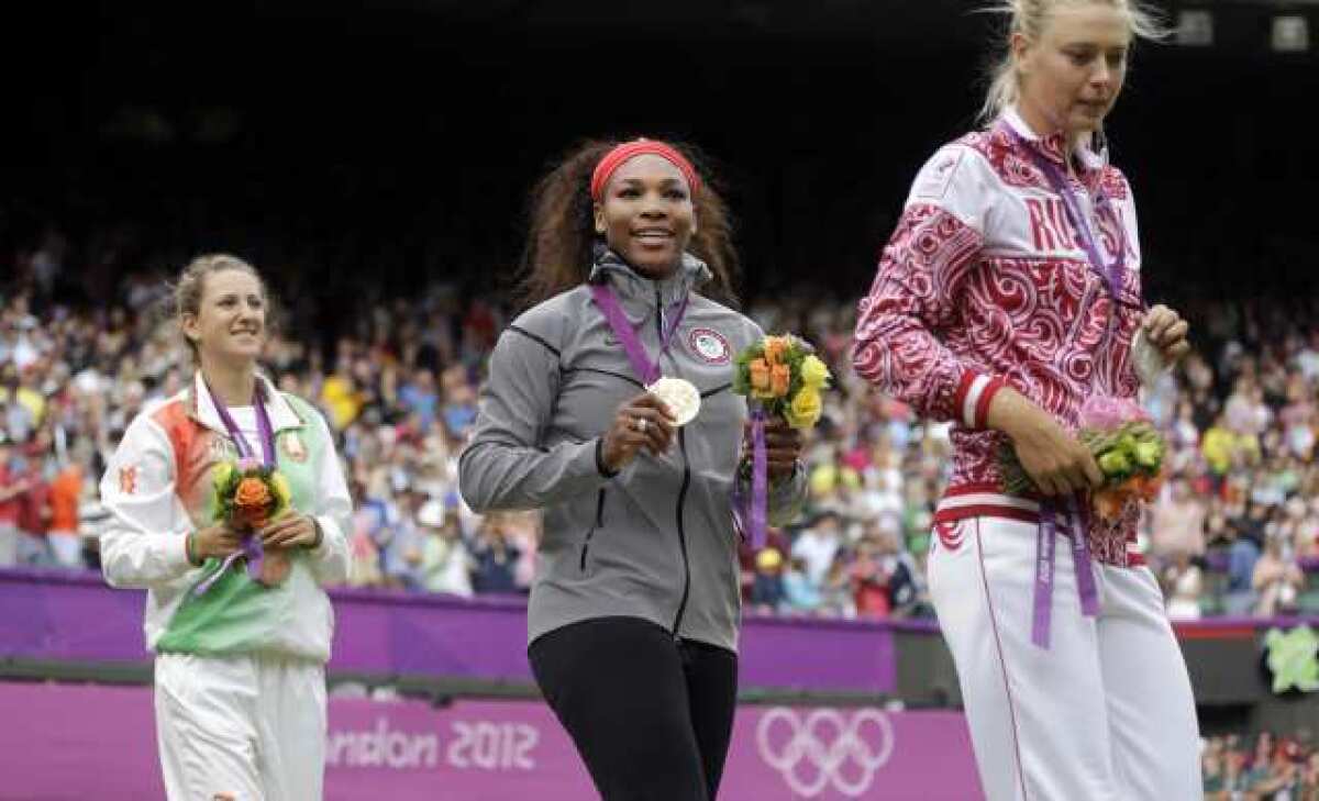 Serena Williams stands on the gold-medal platform.