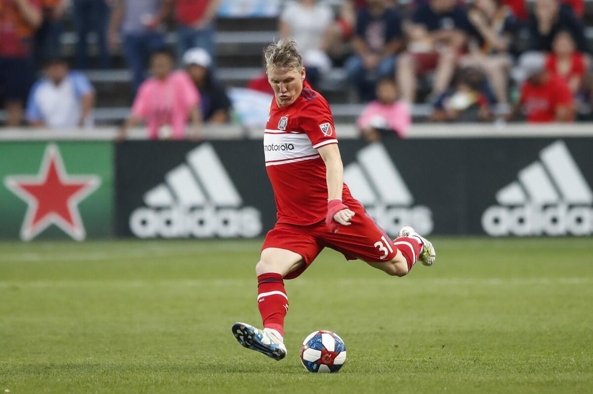 FILE - In this June 22, 2019, file photo, Chicago Fire midfielder Bastian Schweinsteiger looks to kick the ball against Real Salt Lake during the first half of an MLS soccer match, in Bridgeview, Ill. Former Germany captain Bastian Schweinsteiger says he is retiring from soccer, ending an 18-year professional career. Schweinsteiger announced his retirement over Twitter on Tuesday, Oct. 8, 2019. (AP Photo/Kamil Krzaczynski, File)