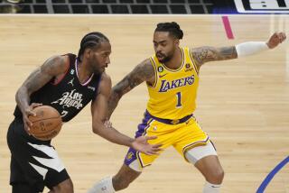 Los Angeles Clippers forward Kawhi Leonard (2) is defended by Los Angeles Lakers guard D'Angelo Russell.