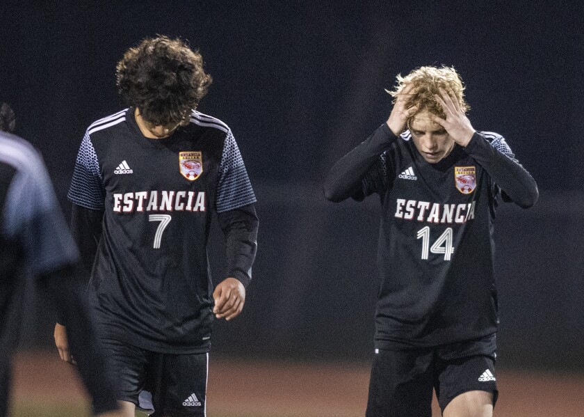Estancia's Kevin Arevalo, left, and John Uchytil leave the field following a 3-1 loss to Santa Ana.