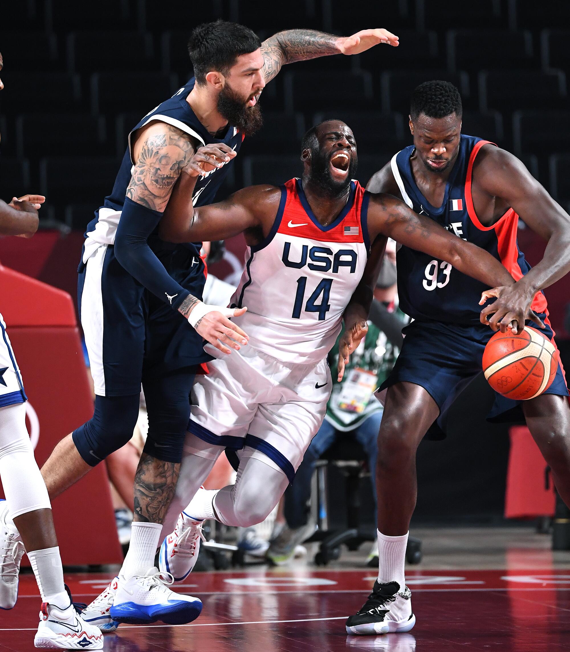  USA's Draymond Green is fouled by France's Vincent Poirier.