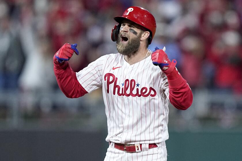 Philadelphia Phillies' Bryce Harper celebrates after his RBI double during the fifth inning.