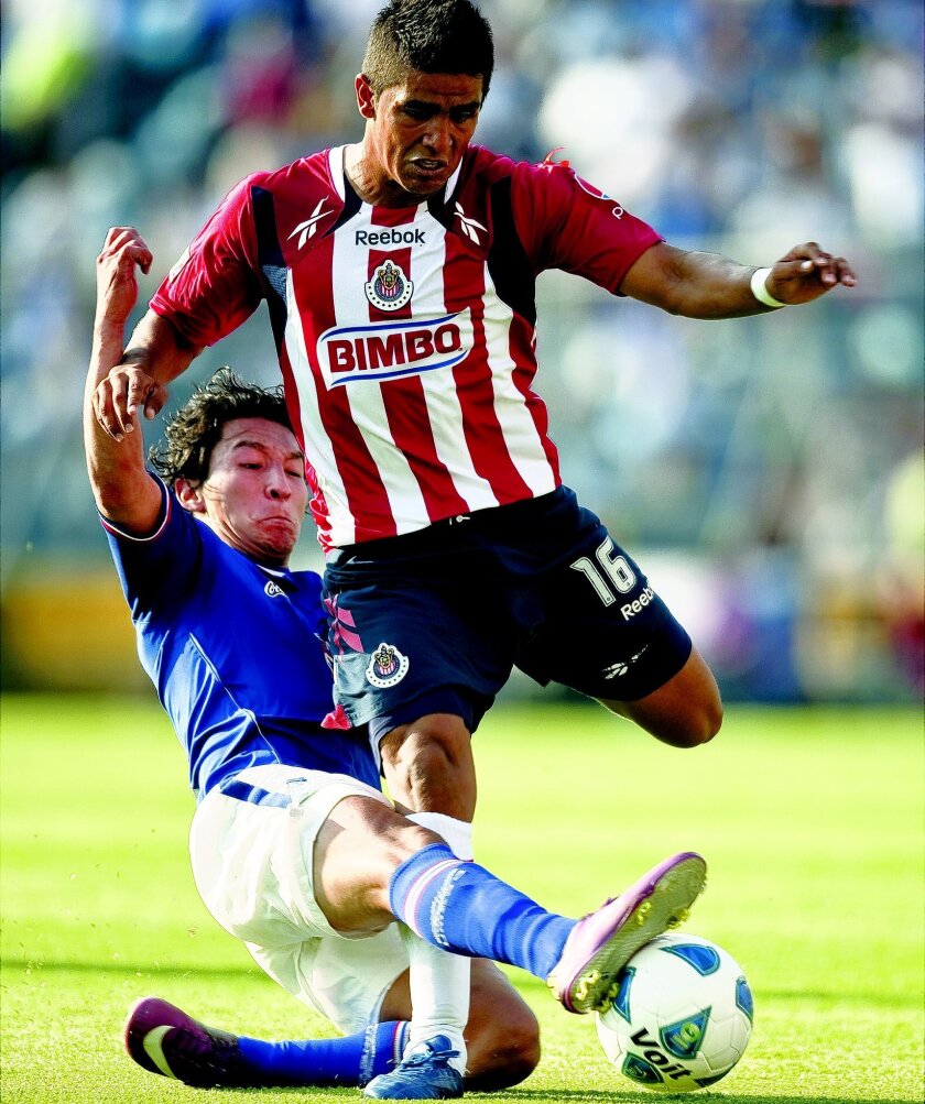 Miguel Angel Ponce of Chivas of Guadalajara (right), who was born in Sacramento and attended school in San Ysidro, vies for the ball with Cesar Villaluz of Cruz Azul.
