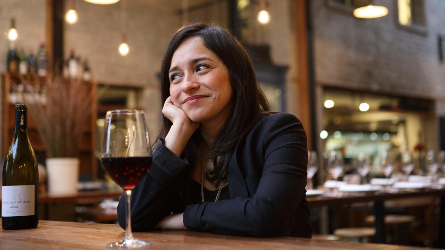 Sommelier Maria Garcia sits for a portrait with a glass of wine at Republique restaurant.