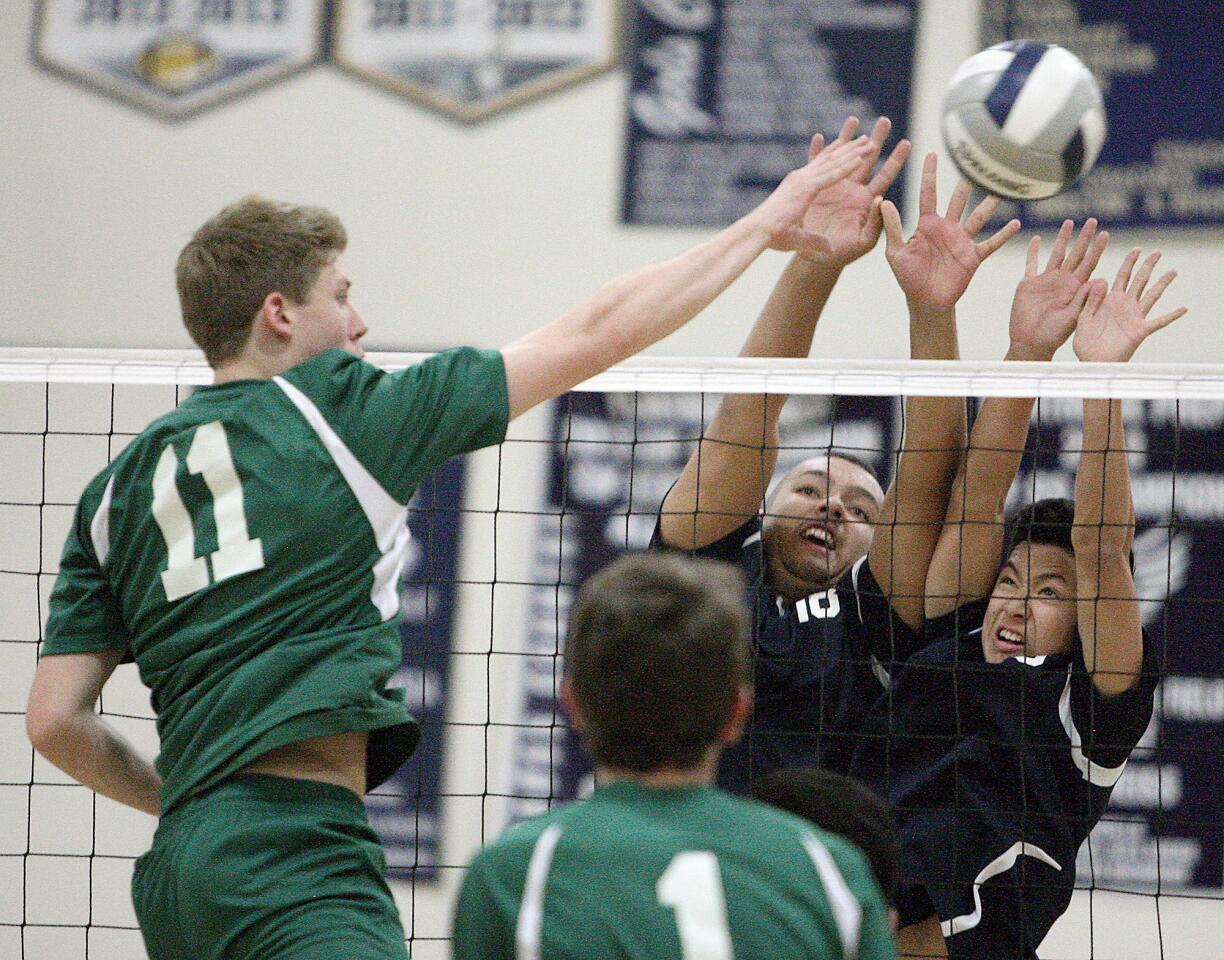 Flintridge Prep's Trip Westmoreland and Kyle Law block Damien's John Prata during a CIF SS Division IV playoff match on Thursday, May 15, 2014.