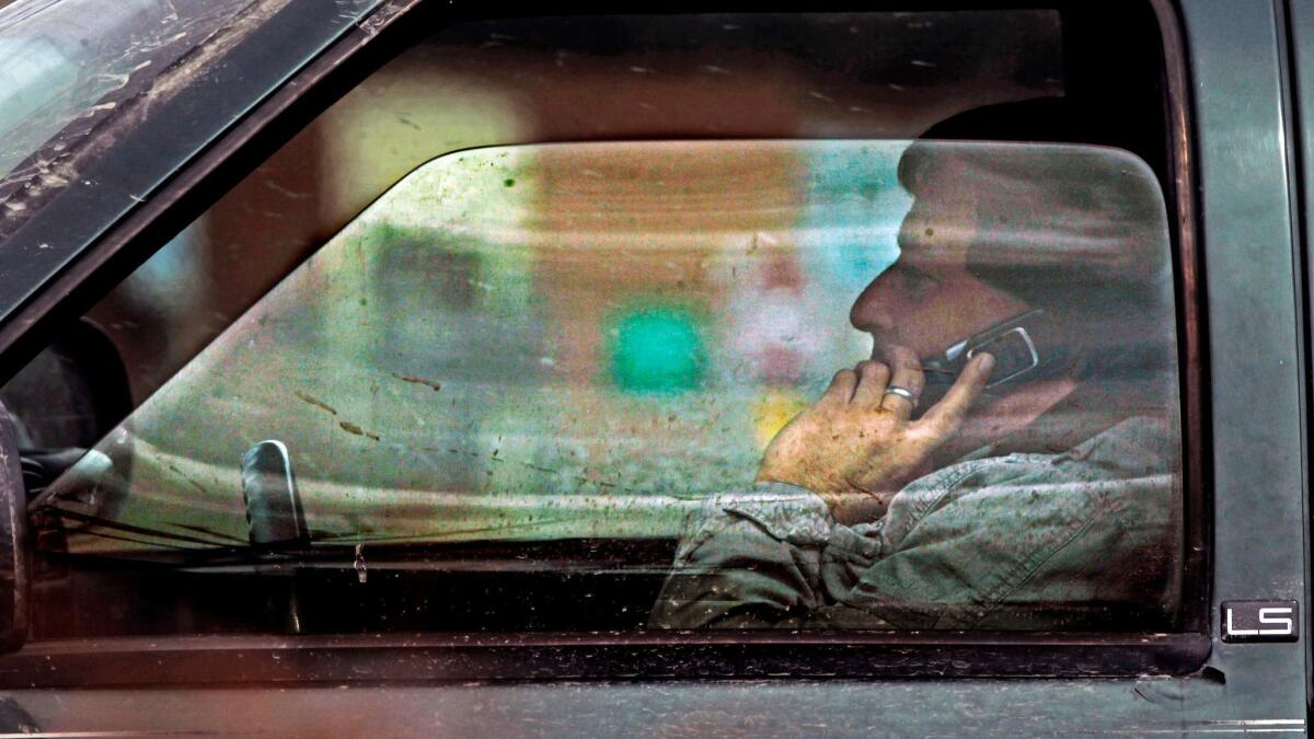 A man talks on the phone while driving in Montpelier, Vt. on Tuesday, April 2, 2013.