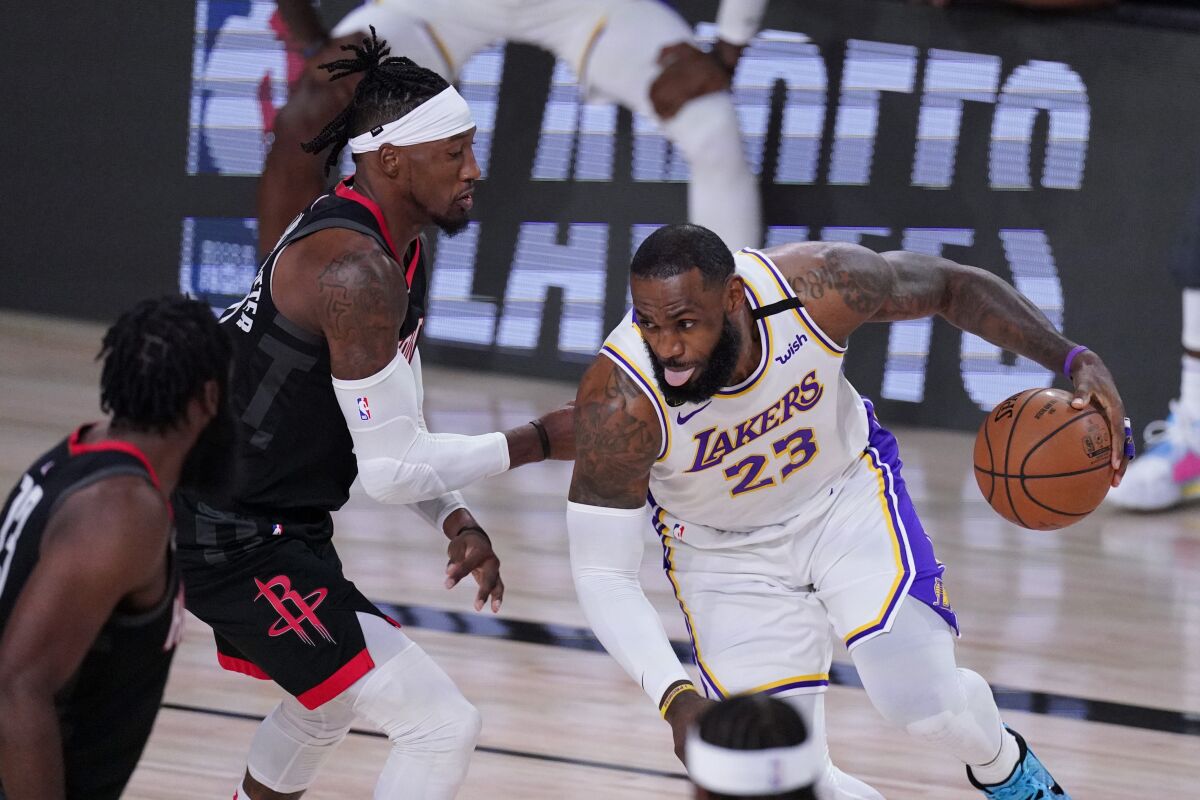 Lakers' LeBron James drives to the basket against the Houston Rockets.