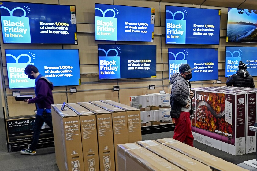 FILE - People look at televisions during a Black Friday sale at a Best Buy store on Friday, Nov. 26, 2021, in Overland Park, Kan. Prices for U.S. consumers jumped 6.8% in November compared with a year earlier as surging costs for food, energy, housing and other items left Americans enduring their highest annual inflation rate since 1982. (AP Photo/Charlie Riedel, File)